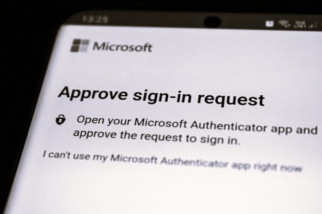 A smartphone screen displaying a Microsoft Authenticator "Approve sign-in request" message, emphasising multi-factor authentication as a cybersecurity control.